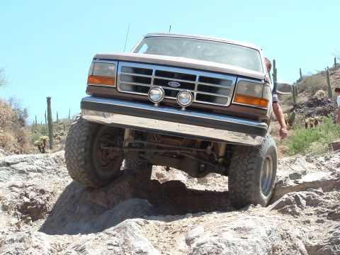 1990 Ford Bronco - This 1990 Ford Bronco navigates a challenging rocky trail during an off-road excursion.