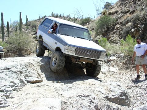1993 Ford Bronco - Off-road adventure in a 1993 Ford Bronco navigating a challenging rocky trail.