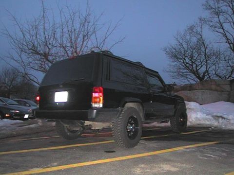 2000 Jeep Liberty - Rear view of a black 2000 Jeep Liberty parked in a lot during twilight.