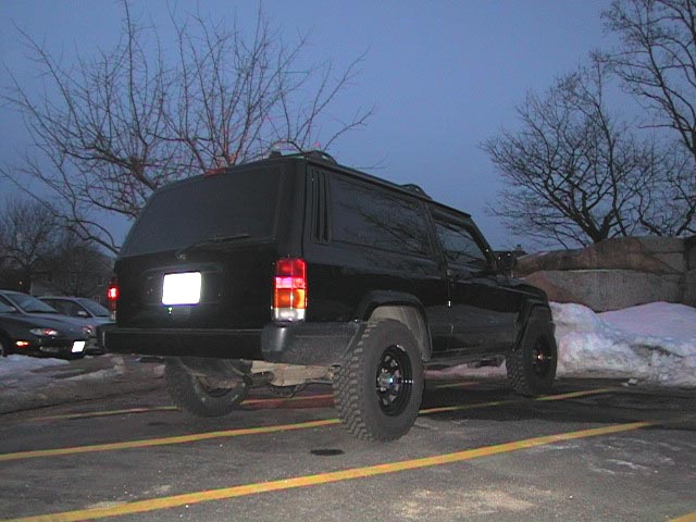 Black 2000 Jeep Liberty parked in a lot with snow on the ground