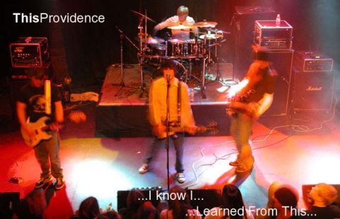 2000 Jeep Liberty - A band plays a live set on stage, illuminated by stage lights.