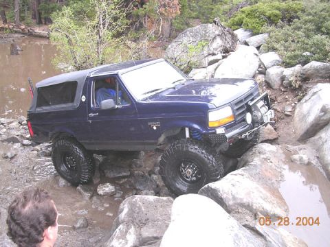1994 Ford Bronco - This blue Ford Bronco is shown off-roading over rocks and through water on May 28, 2004.