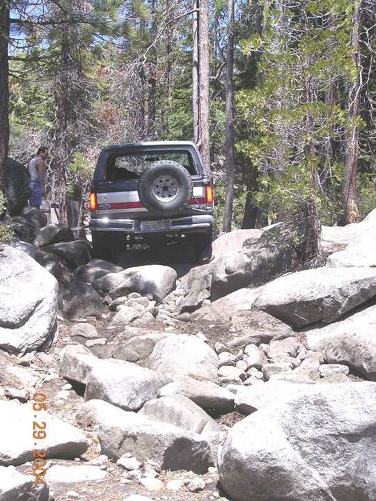 Dan landed the tranny pan on a big rock, which dented up and prevented him from shifting out of 1st Low (luckily he had a forward gear) so he could not back up, which made cadillac fun.  here he is starting cadillac