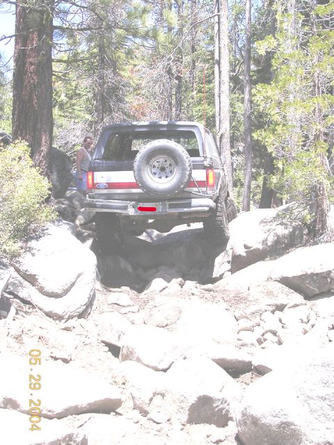 1994 Ford Bronco - A 1994 Ford Bronco navigates a challenging rocky path, its off-road capabilities.