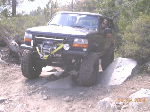 1994 Ford Bronco - Ford Bronco tackles rocky terrain on an off-road trail.