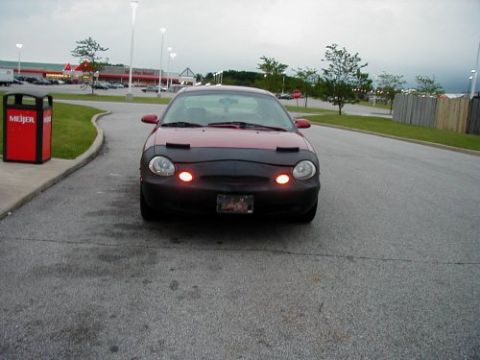 1997 Ford Taurus - 1997 Ford Taurus parked in front of a Meijer store, showing its front end with a car bra.