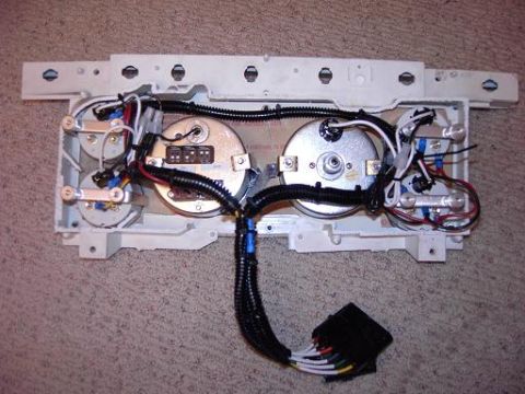 1980 Ford Bronco - Underside view of a vehicle's dashboard gauge cluster and its associated wiring harness.