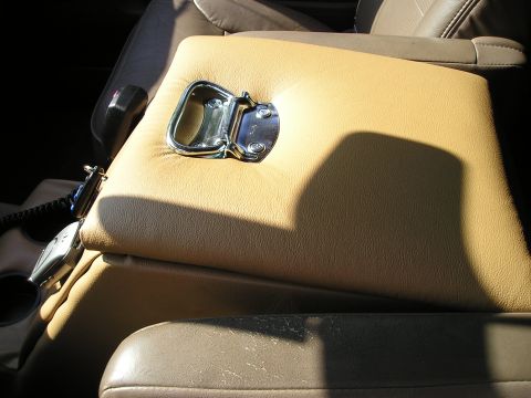 1996 Ford Bronco - Interior view of a tan center console with a chrome latch, likely from a 1996 Ford Bronco.