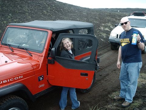 1996 Ford Bronco - Two Jeeps are parked on a dirt road with people enjoying the outdoors.
