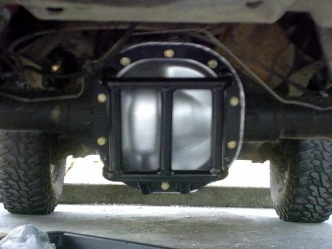 1995 Ford Bronco - Aftermarket differential cover and diff guard installed on a vehicle's rear axle.