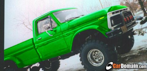 1990 Ford Bronco - This modified pickup truck features a bright green paint job and off-road tires.