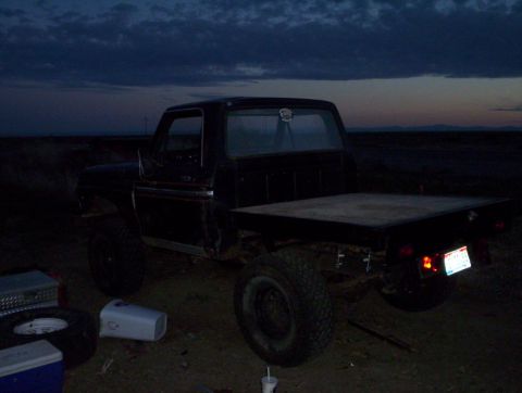 1978 Ford Bronco - Flatbed truck parked outdoors during twilight. The vehicle appears to be a 1978 Ford F-Series.