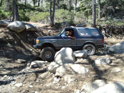 1989 Ford Bronco - This 1989 Ford Bronco is shown tackling a difficult off-road path with large rocks.