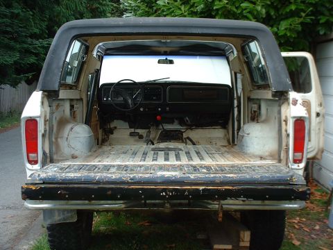 1978 Ford Bronco - Rear view of a 1978 Ford Bronco showing the interior and cargo space, with the tailgate down.