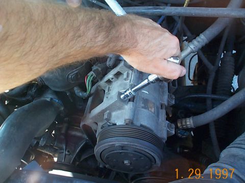 1992 Ford Bronco - Start to remove the A/C bolts.