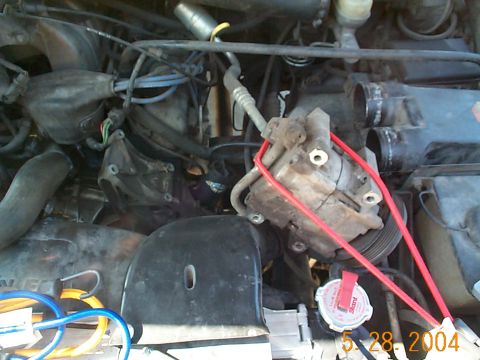 1992 Ford Bronco - Once all of the bolts are removed use a bungee cord to hold the compressor out of the way. The bracket is now easily accessable.