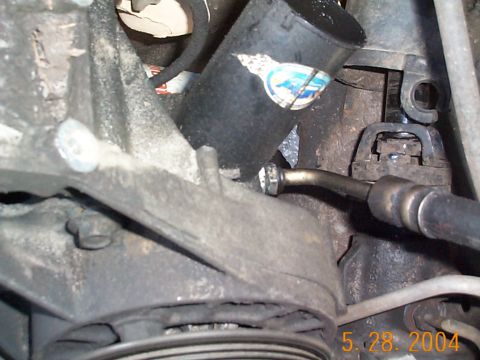 1992 Ford Bronco - Next I'll remove the high pressure line from the pump and then the gear box. My old C2 pump was really beat up. The plastic pulley was even…