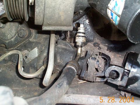 1992 Ford Bronco - The pressure fitting removed from the pump. At this point, don't forget to remove the return line otherwise you'll have a difficult time ta…