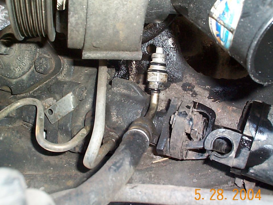 The pressure fitting removed from the pump. At this point, don't forget to remove the return line otherwise you'll have a difficult time taking the pump out.
