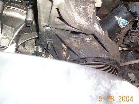 1992 Ford Bronco - Now you can remove the bolts from the pump bracket, there are 3 bolts and one nut.