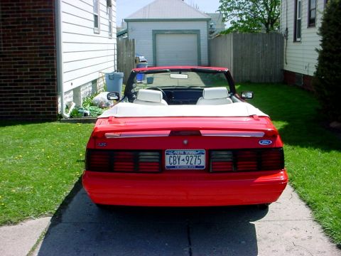 1973 Ford Ranchero - Rear view of a red convertible parked in a driveway with a garage in the background.