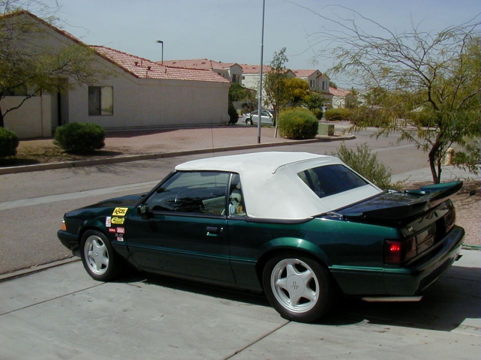 Green Fox-body Mustang convertible with white top in a driveway