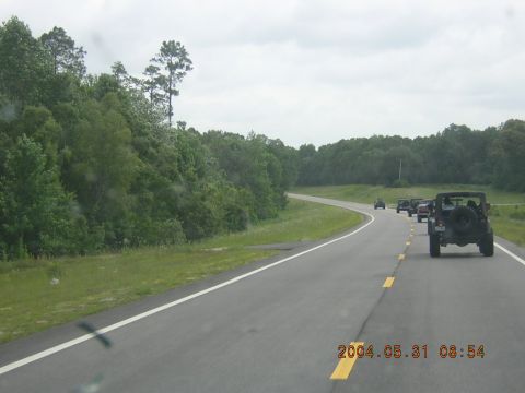1984 Chevrolet Blazer - A group of Jeeps travels down a highway on a cloudy day. The date stamp indicates May 31, 2004.