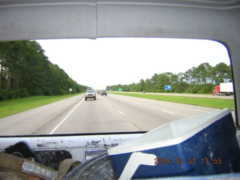 1984 Chevrolet Blazer - A view from inside a vehicle shows a highway scene with other vehicles and trees lining the road.