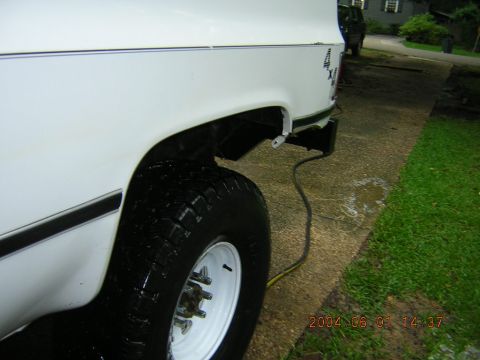 1984 Chevrolet Blazer - Rear view of a white SUV with a missing bumper and a visible tire.