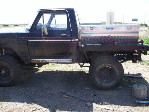 1978 Ford Bronco - This flatbed truck, possibly a 1978 Ford, features a large diamond-plate toolbox mounted on the bed.