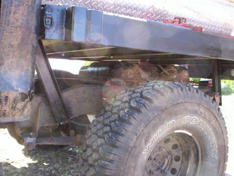 1978 Ford Bronco - Undercarriage view of a truck, focusing on the tire and suspension system.