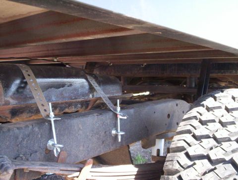 1978 Ford Bronco - The underside of a vehicle displays a fuel tank and a portion of a tire, with visible frame components.