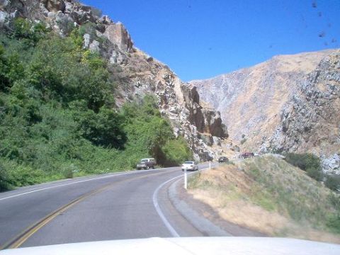 1988 Ford Bronco - A scenic drive through a mountainous canyon with several vehicles on the road.
