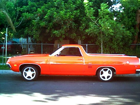 1970 Ford Ranchero - Side profile of a 1970 Ford Ranchero GT with distinctive two-tone paint and custom wheels.