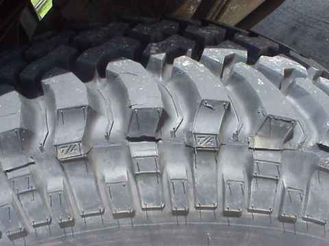 1989 Ford Bronco - The aggressive tread pattern of an off-road tire is shown in detail.