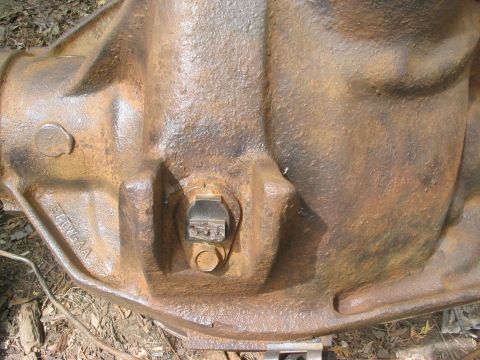 1986 Ford Bronco - Close-up of a rusty differential housing, likely a Sterling 10.25, with visible casting marks.