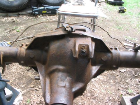 1986 Ford Bronco - Close-up of a rusty rear axle differential housing, likely removed from a vehicle for repair or replacement.