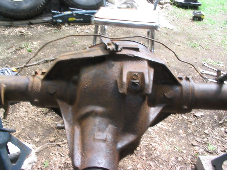 Rusted rear axle differential housing with brake line attached