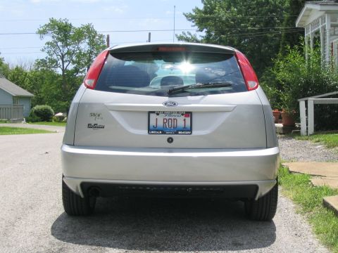 2003 Ford Focus - The rear of a silver 2003 Ford Focus hatchback is shown, a custom license plate and a clean exterior.