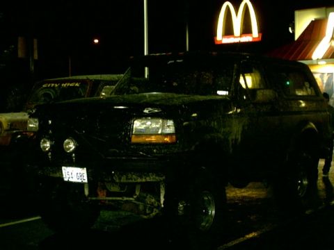1995 Ford Bronco - A 1995 Ford Bronco is parked at night, with a McDonald's sign illuminated behind it.