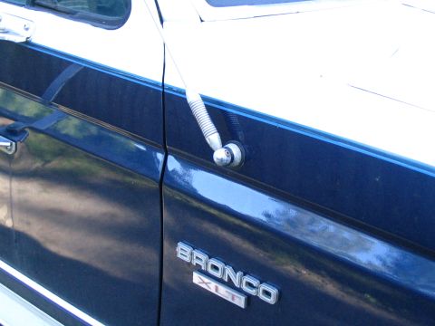 1984 Ford Bronco - The side panel of a Ford Bronco XLT shows its model name and trim level.