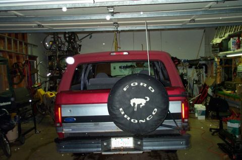 1995 Ford Bronco - Rear view of a red 1995 Ford Bronco parked inside a garage.