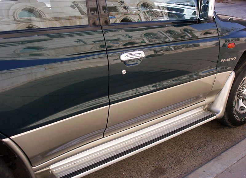 Green and gold Mitsubishi Pajero side detail with chrome running board and PAJERO badge