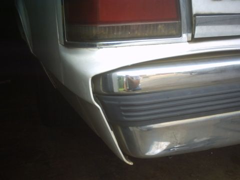 1991 Ford LTD Crown Victoria - Close-up of a car's rear corner, focusing on the bumper and taillight assembly.