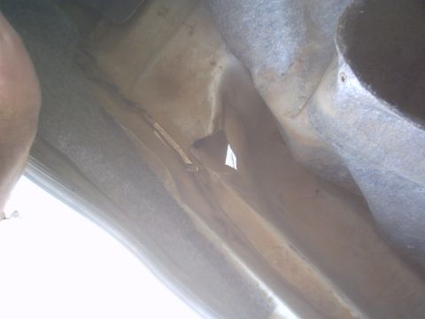 1991 Ford LTD Crown Victoria - The underside of a vehicle is shown, with a focus on the frame and suspension parts.