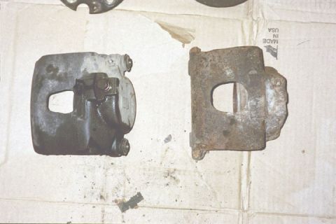1994 Ford Bronco - Comparison of a used brake caliper next to a heavily corroded one.