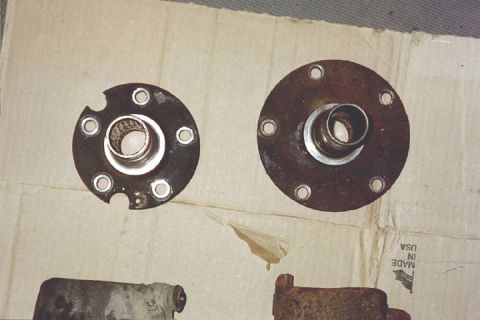 1994 Ford Bronco - Two rusty wheel hubs, one with chipped edges, are shown on a piece of cardboard.