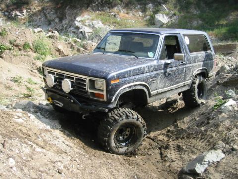 1985 Ford Bronco - This lifted 1980-1986 Ford Bronco navigates a challenging off-road course.