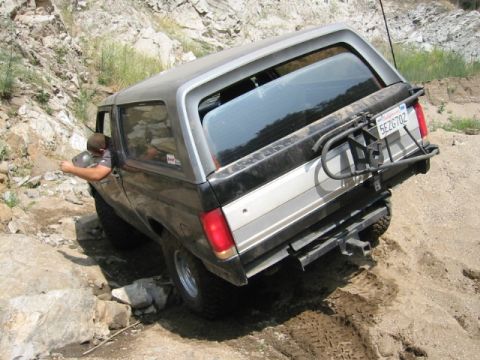 1988 Ford Bronco - This 1988 Ford Bronco navigates a challenging off-road course with a spare tire carrier mounted on the rear.