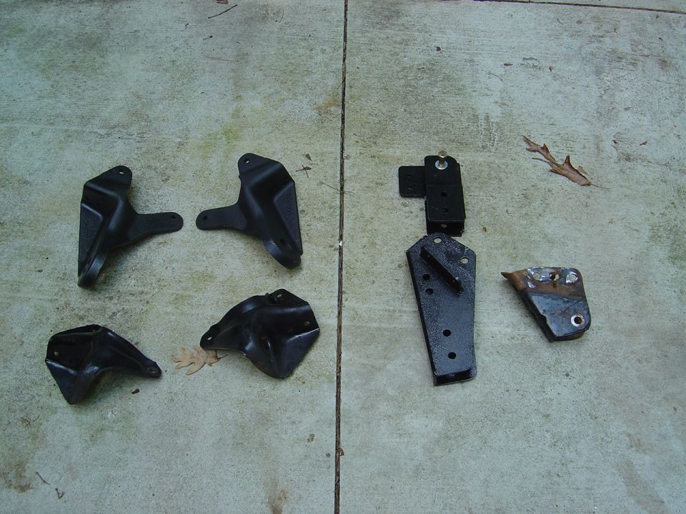 Assorted black steel mounting brackets on concrete